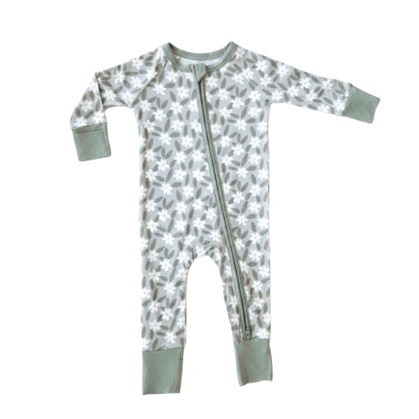A baby long-sleeve footed sleeper with a gray and white floral pattern, featuring sage green cuffs and a matching green zipper.