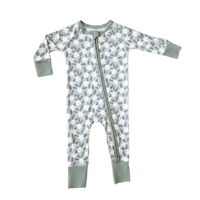 A baby long-sleeve footed sleeper with a gray and white floral pattern, featuring sage green cuffs and a matching green zipper.