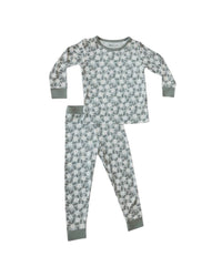 A two-piece children's pajama set featuring a long-sleeve top and matching pants in a sage green and white dalmatian print, with solid sage green cuffs and hem.