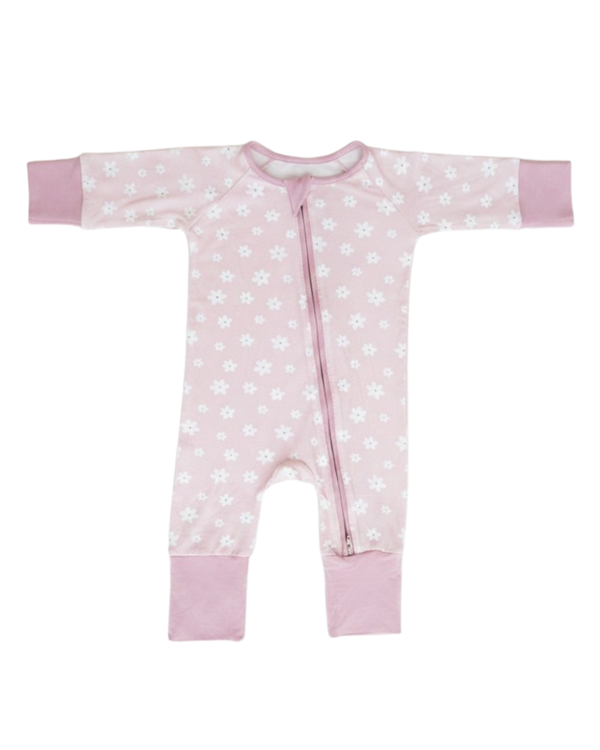 A light pink long-sleeve baby footless sleeper with a white floral pattern, pink cuffs, and a front zipper, shown flat on a white background.