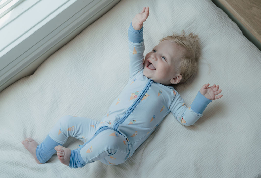 Hel kroppsbild av baby i pyjamas